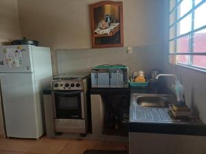a kitchen with a white refrigerator and a sink at De vuelta a casa in Zarate Isla