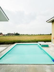 a large blue swimming pool on top of a house at The Canal Villa in Sungai Besar +9 photos