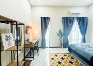 a bedroom with a bed and a desk and a table at The Canal Villa in Sungai Besar