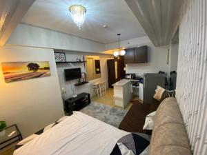 a living room with a couch and a kitchen at Avida Tower 1 in Cagayan de Oro