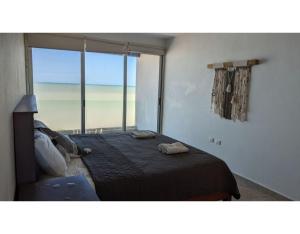 une chambre avec un lit avec vue sur la plage dans l'établissement Villa Caracol - Hello Progreso, à San Benito 36 autres photos