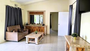 a living room with a couch and a table at Island Nest Apartment in Willemstad