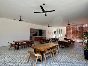 a dining room with wooden tables and chairs at Boho chic, fresh, modern apartment in Ixtapa