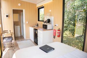 a small kitchen with a sink and a microwave at Bush by the Bay by Tiny Away in River Heads