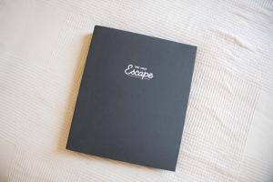 a book sitting on top of a bed at Bush by the Bay by Tiny Away in River Heads