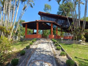 a pavilion in a garden with a path leading to it at Sítio dos Leões em Guapimirim cercado de Lazer e Natureza in Guapimirim