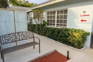 a bench sitting outside of a building at Island Retreat Studio #4 in Nassau