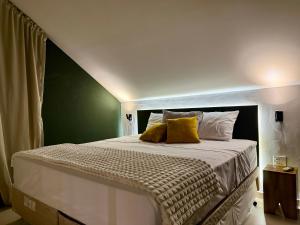 ein Schlafzimmer mit einem großen Bett mit gelben Kissen in der Unterkunft Vila Chalés in Mucuri