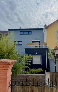 a blue house with surfboards on top of it at Suite de 35 m2 in Les Lilas