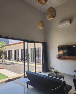 a living room with a couch and a large window at Bali Thousand Island Living in Pesanggaran