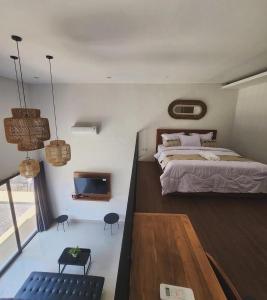 a bedroom with a large bed and a tv at Bali Thousand Island Living in Pesanggaran +11 photos