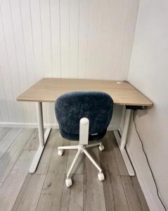 a desk with a blue chair and a wooden table at Sunlit Sands Destin Condo in Destin +15 photos