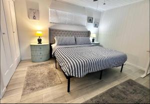 a bedroom with a bed with a striped comforter at Sunlit Sands Destin Condo in Destin