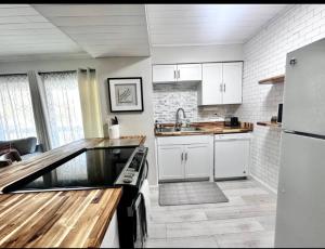 a kitchen with white cabinets and a counter top at Sunlit Sands Destin Condo in Destin