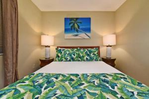 a bedroom with a large bed with two lamps at Pacific Shores B102 · PacSB102 Family Getaway 3BD Across Beach in Kihei +43 photos