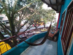 a hammock on the side of a building with a tree at Kumho in Medellín