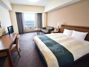a hotel room with a bed and a desk at Star Gate Hotel Kansai Airport in Izumi-Sano