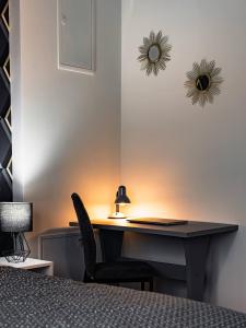 a desk with a lamp and a chair in a room at LuxCity Apartment in the Center of Nowy Targ, FREE PARKING in Nowy Targ +22 photos