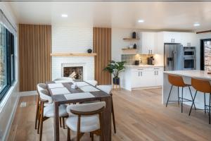 a kitchen and living room with a table and chairs at Modern Entire Home Near UVA in Charlottesville
