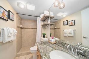 a bathroom with a sink and a toilet at Kihei Surfside 306 · KSS 306 Updated BeachFront 1BD w Ocean View in Wailea +43 photos
