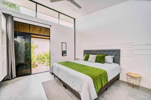 una camera da letto con un letto grande con una coperta verde di Gaviota Suite 3 a Puerto Viejo