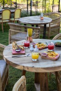 a wooden table with food and drinks on it at Wildflower Entire Estate in Ungasan