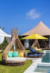 a resort with two wicker beds next to a pool at Wildflower Entire Estate in Ungasan