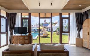 a living room with a view of a pool at Wildflower Entire Estate in Ungasan