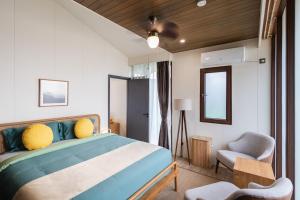 a bedroom with a large bed and a chair at Wildflower Entire Estate in Ungasan +48 photos