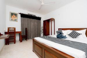 a bedroom with a large bed and a desk at Brescia villa - Your Private Escape in matara in Gandara West
