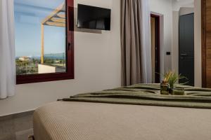 a bedroom with a bed and a window with a view at Adelda Villa in Kypseli