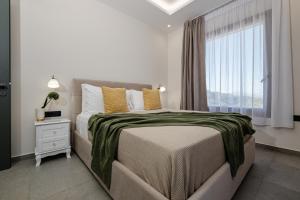 a bedroom with a large bed with a window at Adelda Villa in Kypseli +22 photos