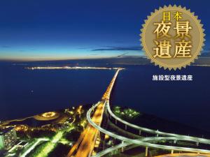 a poster for a city at night with a highway at Star Gate Hotel Kansai Airport in Izumi-Sano