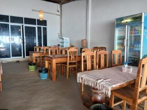 a group of tables and chairs in a room at Nongkhiew Heaven Backpackers Hostel & Tours in Nongkhiaw