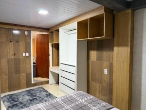 a bedroom with a bed and a closet at Moradas Desterro, próximo ao aeroporto 01 in Florianópolis