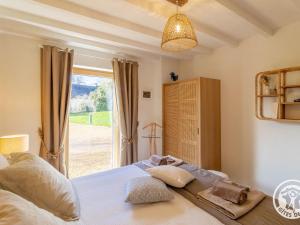 a bedroom with a bed and a large window at Gîte confortable à la campagne, 2 chambres, vue dégagée - FR-1-622-118 in Le Vieil-Baugé