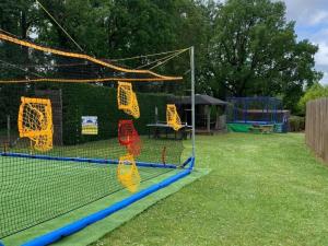 un court de tennis avec un filet dans une cour dans l'établissement Mobil Home 27m² avec Terrasse à Limeuil - 5 personnes - API-1-52-837, à Paunat