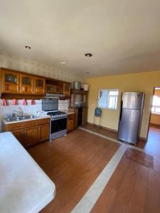 AhuatepecにあるCasa Isabella in Cuernavacaのキッチン(ステンレス製の電化製品、木製キャビネット付)