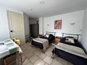 a room with two beds in a room at Studio pratique avec WiFi et parking proche du centre et des Thermes - FR-1-541-184 in La Roche-Posay