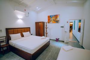 Postel nebo postele na pokoji v ubytování Kami Unawatuna