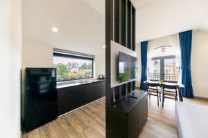 ein Wohnzimmer mit einem TV und einem Esstisch in der Unterkunft ROYAL DRAGON HOTEL in Da Lat + 28 Fotos