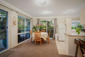 a kitchen and dining room with a table and chairs at Milton Village Retreat - secluded comfort in Milton