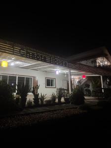 a house lit up at night with lights at Chaota Modern House in Ban Ao Makham
