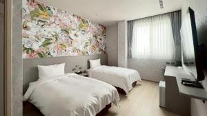 Postel nebo postele na pokoji v ubytování 星雨行館-逢甲洲際館