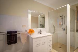 a white bathroom with a sink and a shower at Milton Village Retreat - secluded comfort in Milton +31 photos