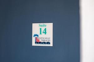 a sign that says smile with many benefits at Ocean View Apartment 14 in Airlie Beach