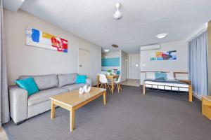 a living room with a couch and a table at Ocean View Apartment 14 in Airlie Beach