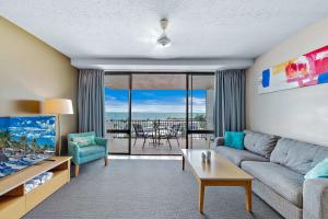 a living room with a couch and a table at Ocean View Apartment 14 in Airlie Beach +14 photos