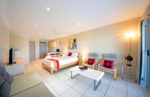 a hotel room with a bed and a couch at Baybliss Escape #3 - Adults Only in Shute Harbour