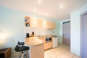 a kitchen with a table and a counter top at Baybliss Escape #3 - Adults Only in Shute Harbour